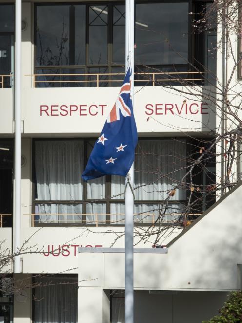 The New Zealand flag flies at half mast at Trinity Catholic College in Dunedin yesterday. PHOTO:...
