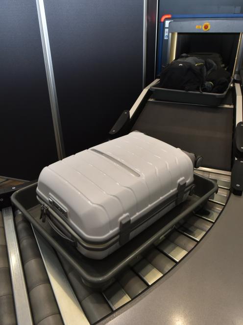 Carry-on luggage is conveyed to a scanner at Dunedin International Airport.