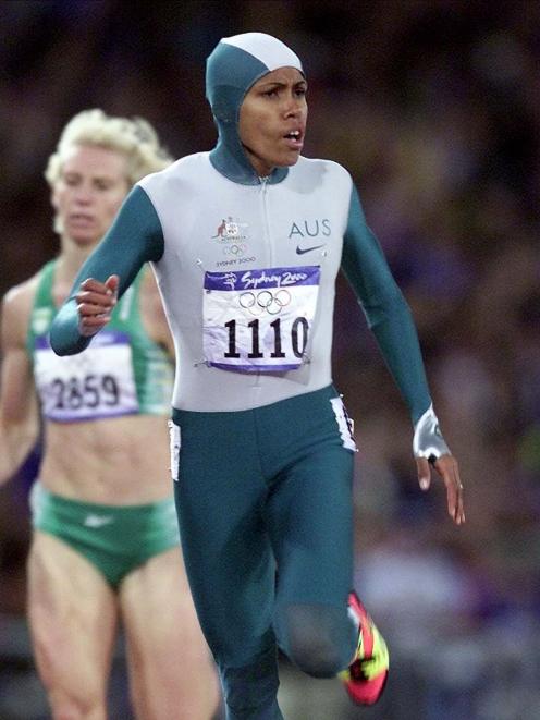 Australian sprinter Cathy Freeman crosses the finish line in her space suit to win the 400m final...