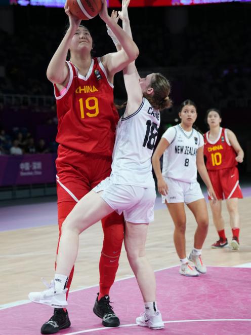 Carline defends Zhang Ziyu during their game. PHOTO: GETTY IMAGES