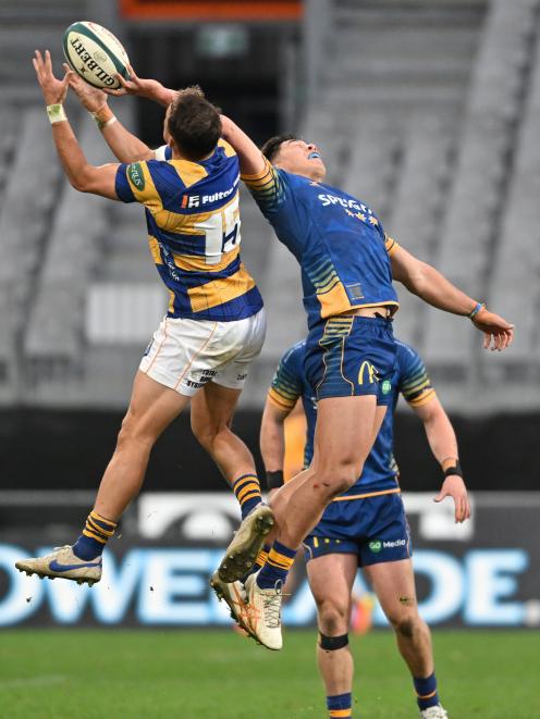 Otago wing Josh Whaanga is at full stretch to steal the high ball from Bay of Plenty fullback...