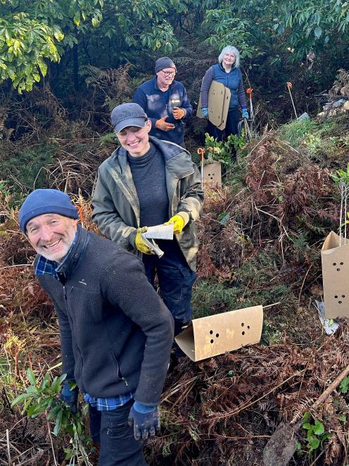 Papatowai conservationists on a forest planting working-bee last month (from left) Blair...