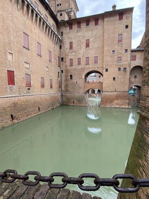 Crossing Este Castle's drawbridge, Ferrara.