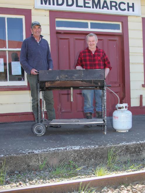 Strath Taieri Lions Club members Steve Marshall (left) and Jock Frew prepare a barbecue to feed revellers at the street party. PHOTO: SUPPLIED