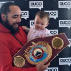 Che Cooper and Ivy Cooper-Waldron (9 months) take hold of  the WBO heavyweight belt custom-made...