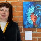 Community arts facilitator Rachel Taylor stands by the work  Headaches, overall winner of the...