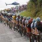A helicopter of the French TV hovers over the pack with Thor Hushovd of Norway, wearing the...