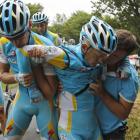 Alexande Vinokourov of Kazakhstan, second right, is helped by his teammates after crashing during...