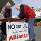 Alliance Party members, from left, Eunice Billot and Gail Marmont collect signatures in South...