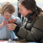 Amy Thorburn helps daughter Audrey (2) make a miniature steamship at the Swashbuckling Steamships...