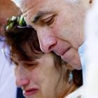 Amy Winehouse's parents, Mitch and Janis, weep as they view floral tributes outside their...