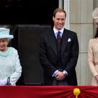 Britain's Queen Elizabeth waves next to Prince William and Catherine, Duchess of Cambridge, on...