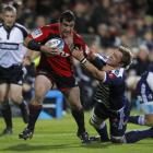 Cory Flynn of the Crusaders is tackled during the round eight Super 15 match against the Stormers...