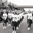 Crowds line the road in Birmingham to watch members of the Blair Atholl marching team in 1952