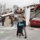 CTV staff comfort each other as rescue personnel work to rescue people trapped in the collapsed...