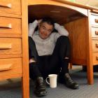 Dunedin Mayor Dave Cull shelters under his desk. Photo by Stephen Jaquiery.