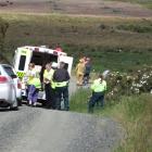 Emergency services deal with an overturned vehicle down a steep bank on Cannibal Bay Rd. The car...