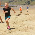 Emmy Marshall (5) is followed by her twin sister Lulu and cousin Benji May (5)  during  the...