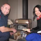 Fire safety officer Stuart Ide shows Enxin Chin, from Singapore, how to properly light a fire in...