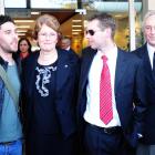 Gil and Lesley Elliott, and sons Chris (left) and Nick (centre), talk to the media outside the...