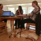 Jessie Lorenz (right) who is blind, sits with her dog Nacho as she works with engineer Mike...