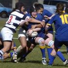 Lisa Waddell, of Otago, is tackled by Auckland defenders Karina Penetito (left) and Bella Milo...