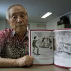 North Korean exile Kim Sang Hun with his book detailing abuse in the secretive country. Photo by...