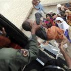 Pakistani army soldiers in a helicopter rescue families stranded by flood water in Sanawan near...