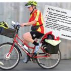 Postie Jane Gibbs heads down Ascot St in Dunedin yesterday. Photo by Peter McIntosh.