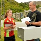 Postie Terri Oakden delivers a letter to Peter Crum, of Arrowtown, yesterday. Photo by Stephen...