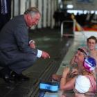 Prince Charles chats with swimmers at the Millenium Sports Institute. (Photo by Phil Walter/Getty...