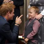 Prince Harry talks to 6-year-old Alex Logan as he attends the WellChild awards ceremony at the...