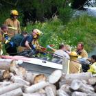 Queenstown and Frankton emergency services personnel tend to injured people aboard the jet-boat...