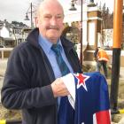 Queenstown RSA vice-president Lyall McGregor holds the New Zealand flag destined for the long...