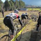 Riders tackle the muddy downhill section during the  national cyclocross championships at Jardine...