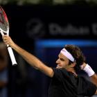 Roger Federer of Switzerland celebrates after beating Andy Murray of Britain to win the Dubai...