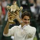 Roger Federer of Switzerland holds the winners trophy after defeating Andy Murray of Britain in...