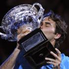 Roger Federer of Switzerland kisses the trophy after beating Andy Murray of Britain to win the...