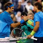 Roger Federer of Switzerland (L) shakes hands with Rafael Nadal of Spain after defeating him in...