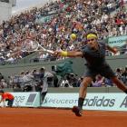 Roger Federer of Switzerland returns the ball to David Goffin of Belgium during the French Open...