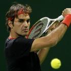 Roger Federer of Switzerland returns the ball to Nikolay Davydenko of Russia during the ATP Qatar...