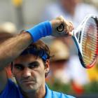 Roger Federer of Switzerland returns the ball to Tomas Berdych of the Czech Republic during their...