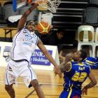 The Wellington Saints' Ernest Scott climbs above the Otago Nuggets' Antoine Tisby to score during...