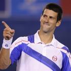 Serbia's Novak Djokovic gestures to his supporters as he celebrates his win over Switzerland's...