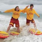 St Clair Surf Life Saving guards Steph Laughton (left) and James Rolfe take to the St Clair surf...