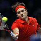 Switzerland's Roger Federer returns the ball to Spain's Rafael Nadal during the singles final...