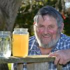 Taieri horticulturist Brian Miller with unfiltered water from his bore at right and filtered...