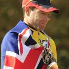 Tour de France winner Cadel Evans of Australia holds a trophy on the podium in Paris at the end...
