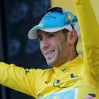 Vincenzo Nibali celebrates with the yellow leader's jersey on the podium after the 155.5km fifth...