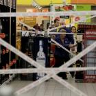 Workers puts tape to close an aisle with hard liquor in a supermarket in Prague. REUTERS/David W...